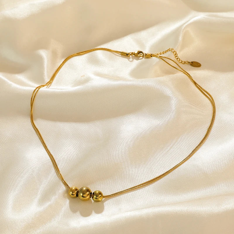 Collier ras du cou EILIECK en acier inoxydable 316L couleur or avec pendentif en perles creuses, inaltérable, idéal pour les cadeaux de fêtes.