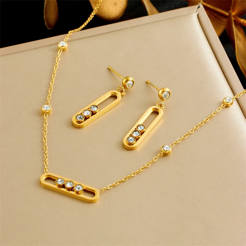 XIYANIKE Ensemble collier, bracelet et boucles d'oreilles en acier inoxydable 316L, forme rectangulaire arrondie, orné de cristaux blancs mobiles. Idée cadeau pour femme.